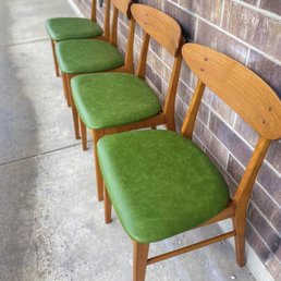 Row of teak chairs in olive green vinyl